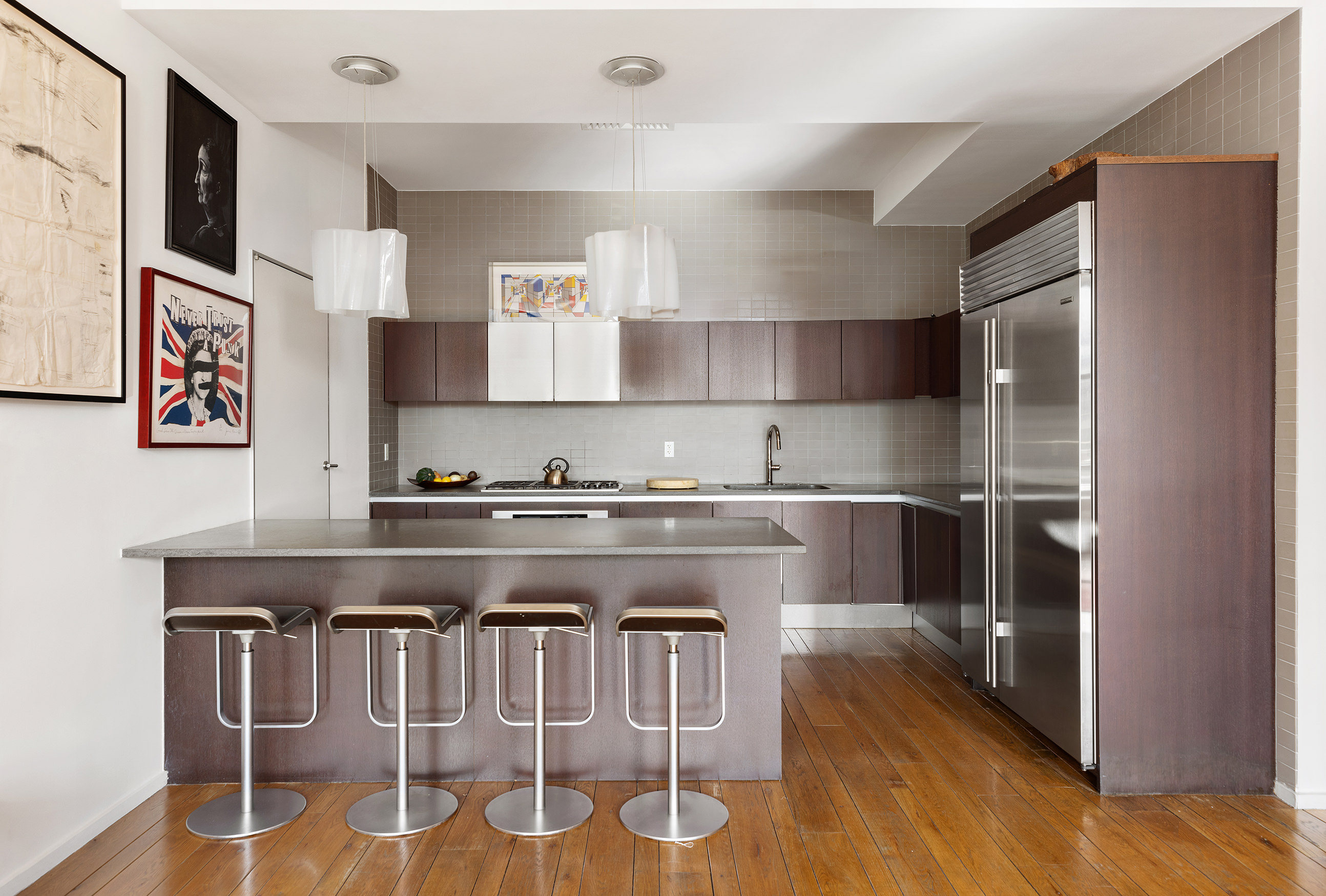 21 Astor Place, Unit 9E Manhattan, NY 10003 - Photo 4 of 10 a kitchen with granite countertop a stove and a refrigerator