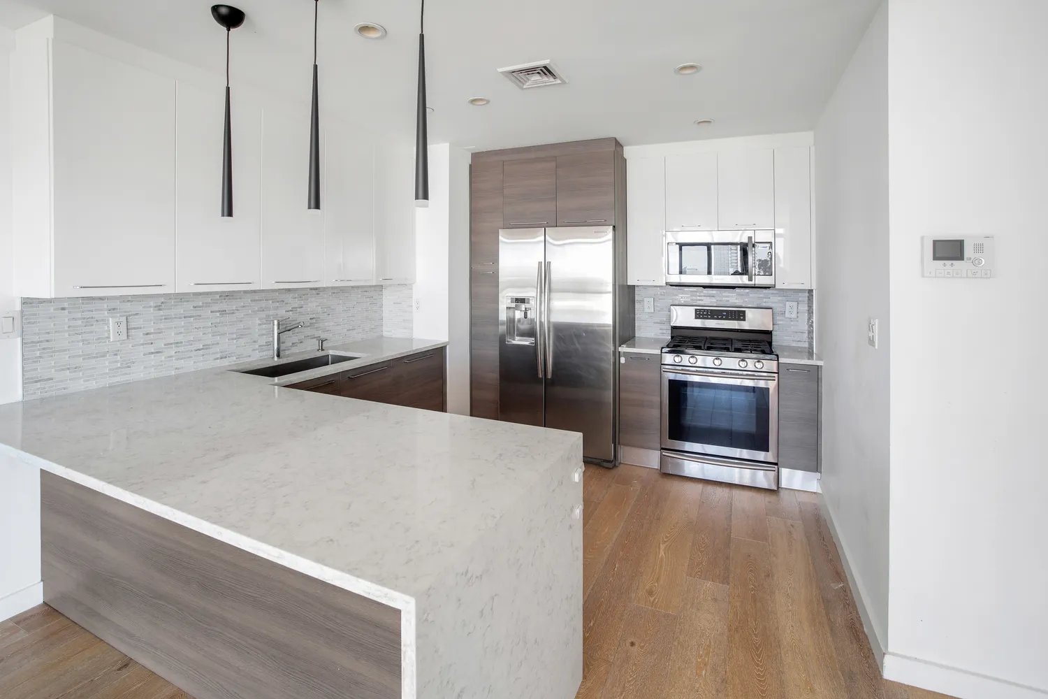 a kitchen with stainless steel appliances a refrigerator sink and stove