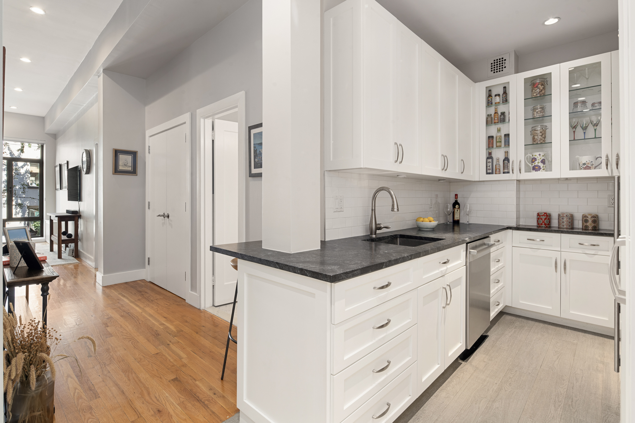 23 East 10th Street, Unit 3C Manhattan, NY 10003 - Photo 6 of 15 a kitchen with granite countertop a sink and cabinets
