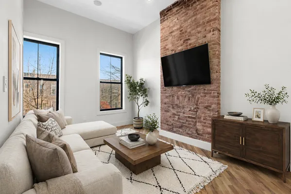 a living room with furniture a fireplace and a flat screen tv