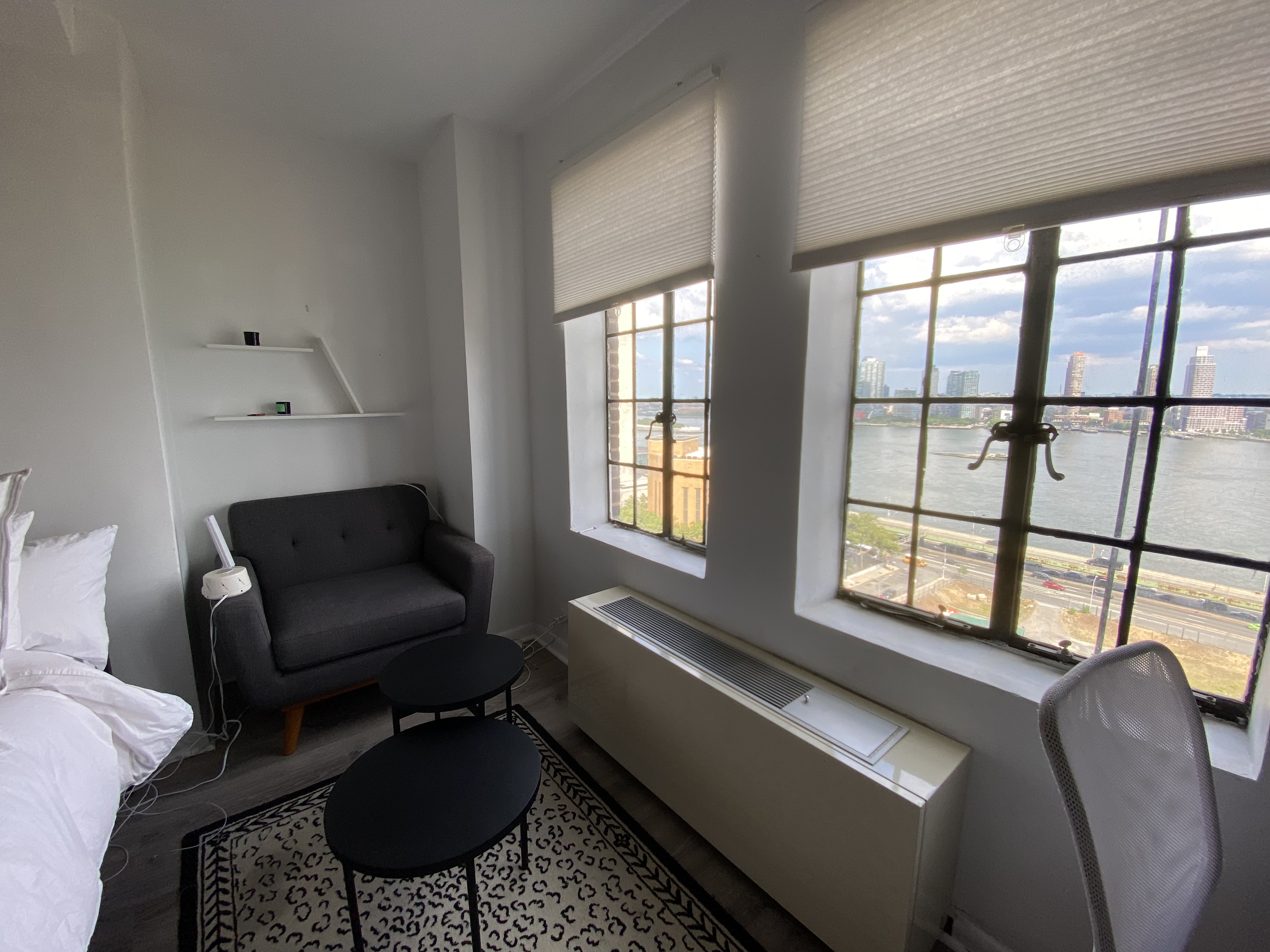 5 Tudor City Place, Unit 1226 Manhattan, NY 10017 - Photo 5 of 10 a living room with furniture and a window