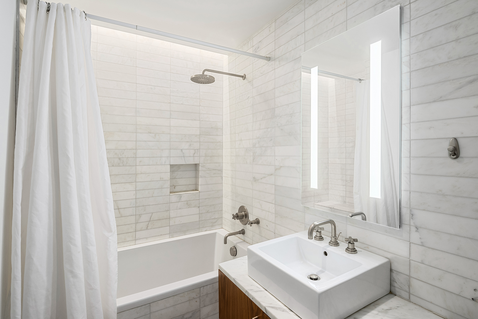 280 Metropolitan Avenue, Unit 3E Brooklyn, NY 11211 - Photo 5 of 12 a bathroom with a sink shower and a bathtub
