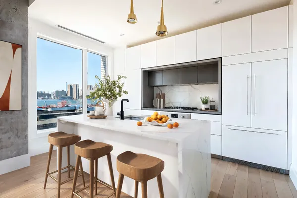 a kitchen with furniture and a wooden floor