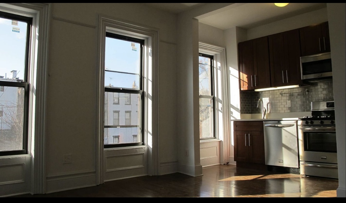 a kitchen with stainless steel appliances a refrigerator and a stove
