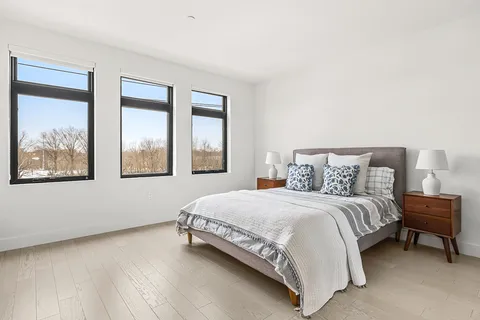 a bedroom with a bed and a painting on the wall