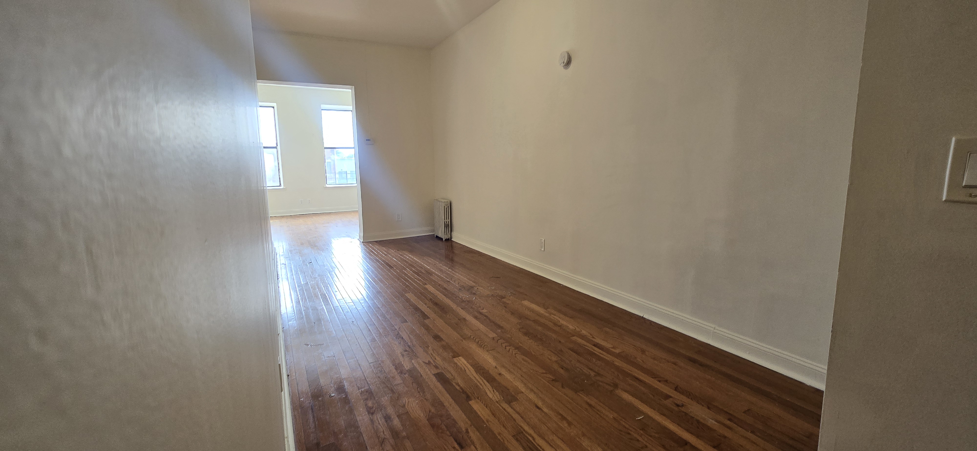 1501 Broadway, Unit 4 Brooklyn, NY 11221 - Photo 3 of 7 a view of wooden floor and windows in a room