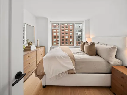 a bedroom with a bed and a large window