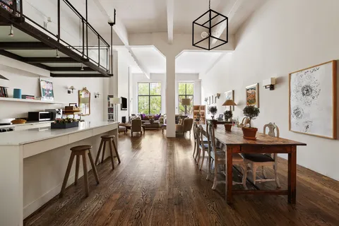 a view of a dining room with furniture kitchen and wooden floor
