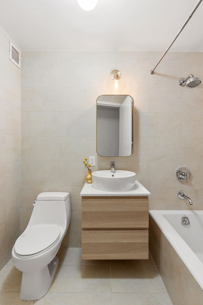 a bathroom with a sink toilet and bathtub