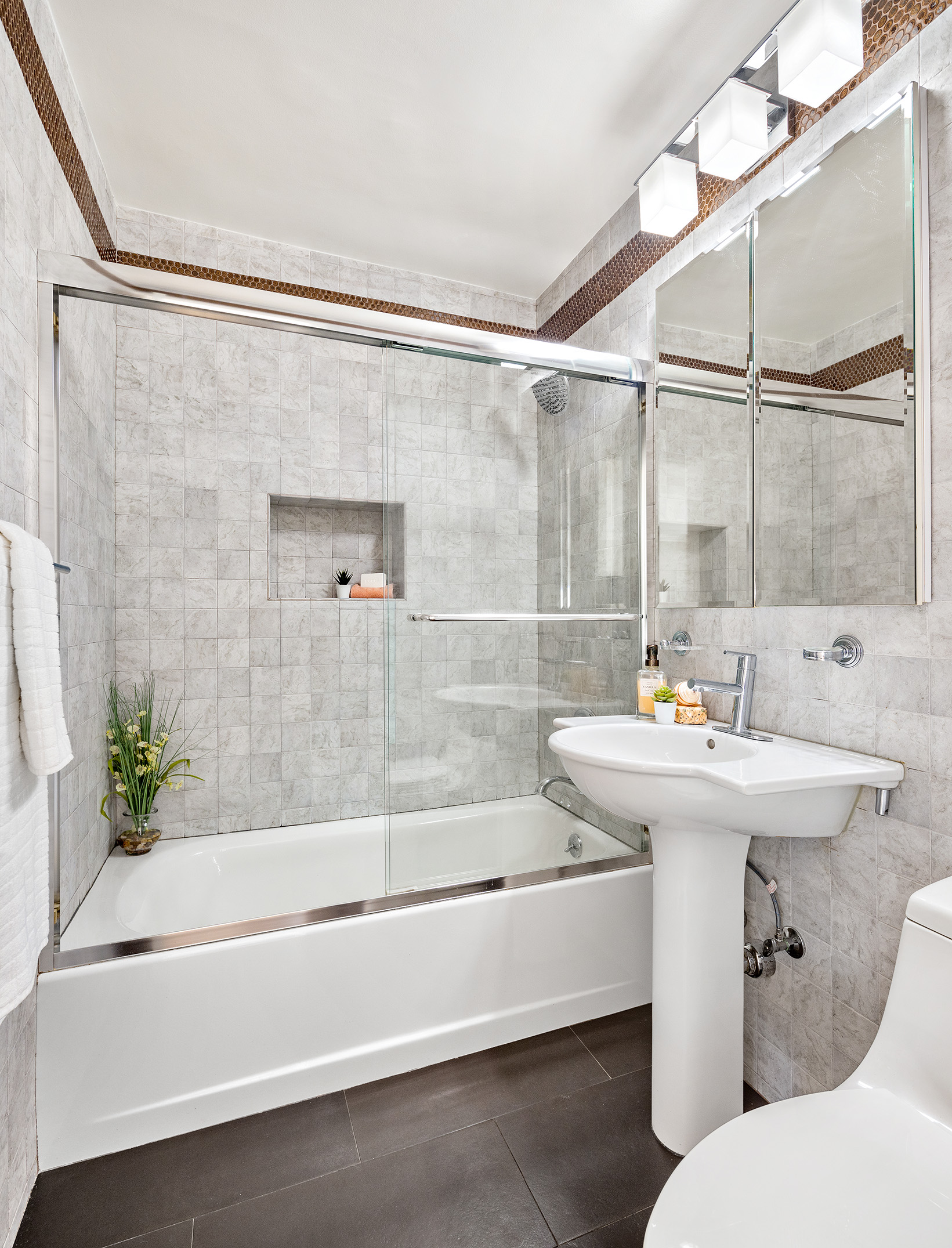 155 East 38th Street, Unit 12K Manhattan, NY 10016 - Photo 13 of 15 a bathroom with a sink and mirror with bathtub