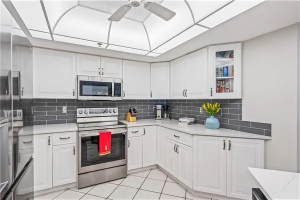 a kitchen with cabinets appliances a sink and a counter top space