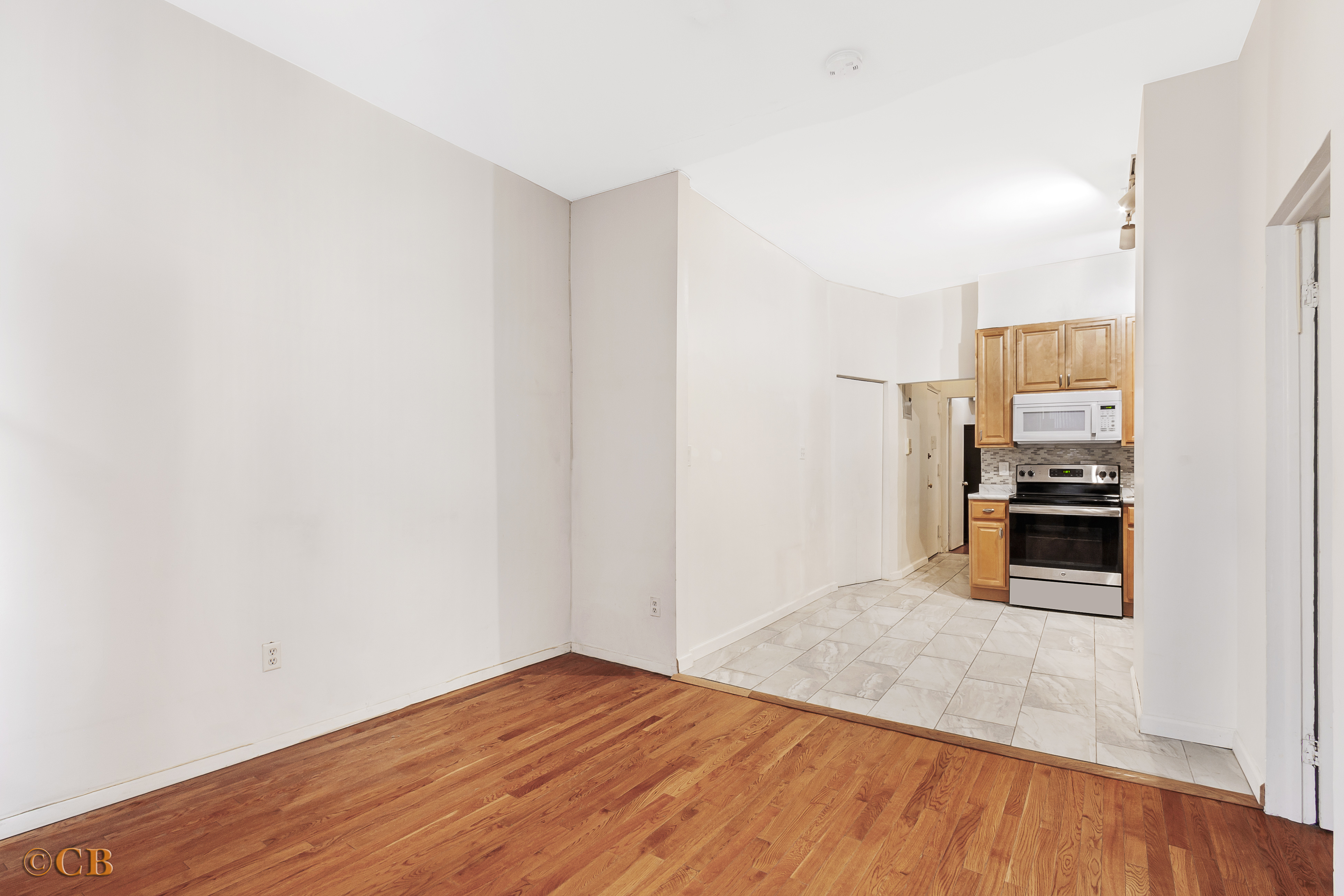 131 Thompson Street, Unit 4C Manhattan, NY 10012 - Photo 3 of 9 a view of a kitchen with wooden floor