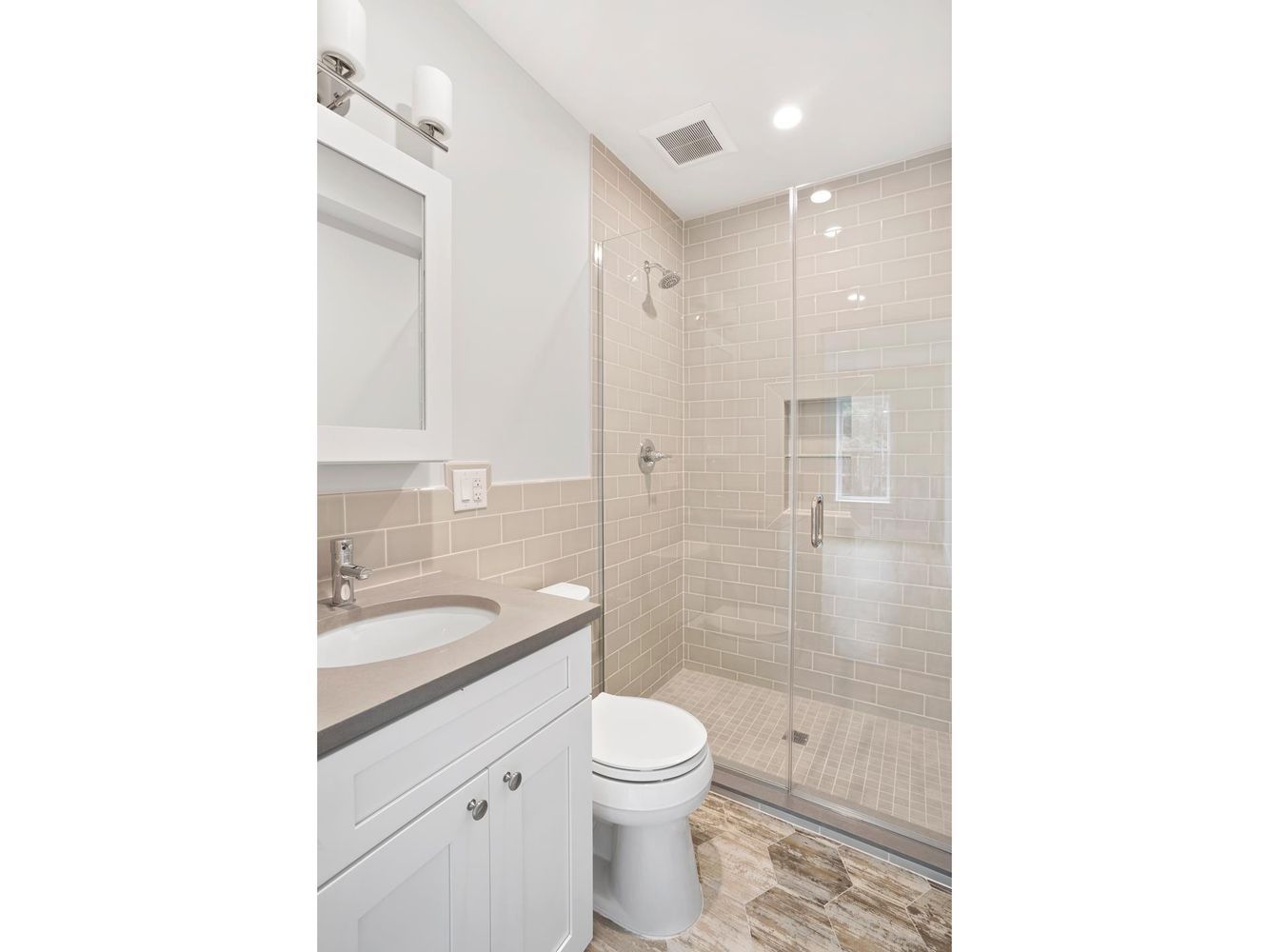136 Union Street, Unit 2 Brooklyn, NY 11231 - Photo 7 of 9 a bathroom with a granite countertop toilet a sink and a mirror