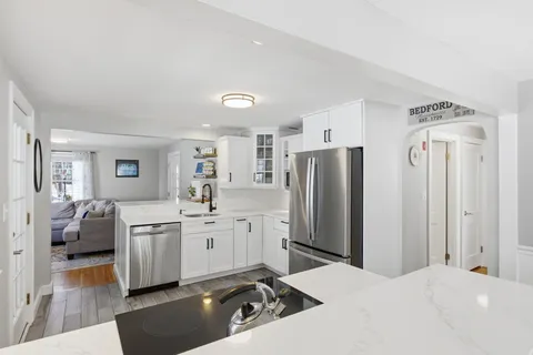 a kitchen with stainless steel appliances a refrigerator sink and stove