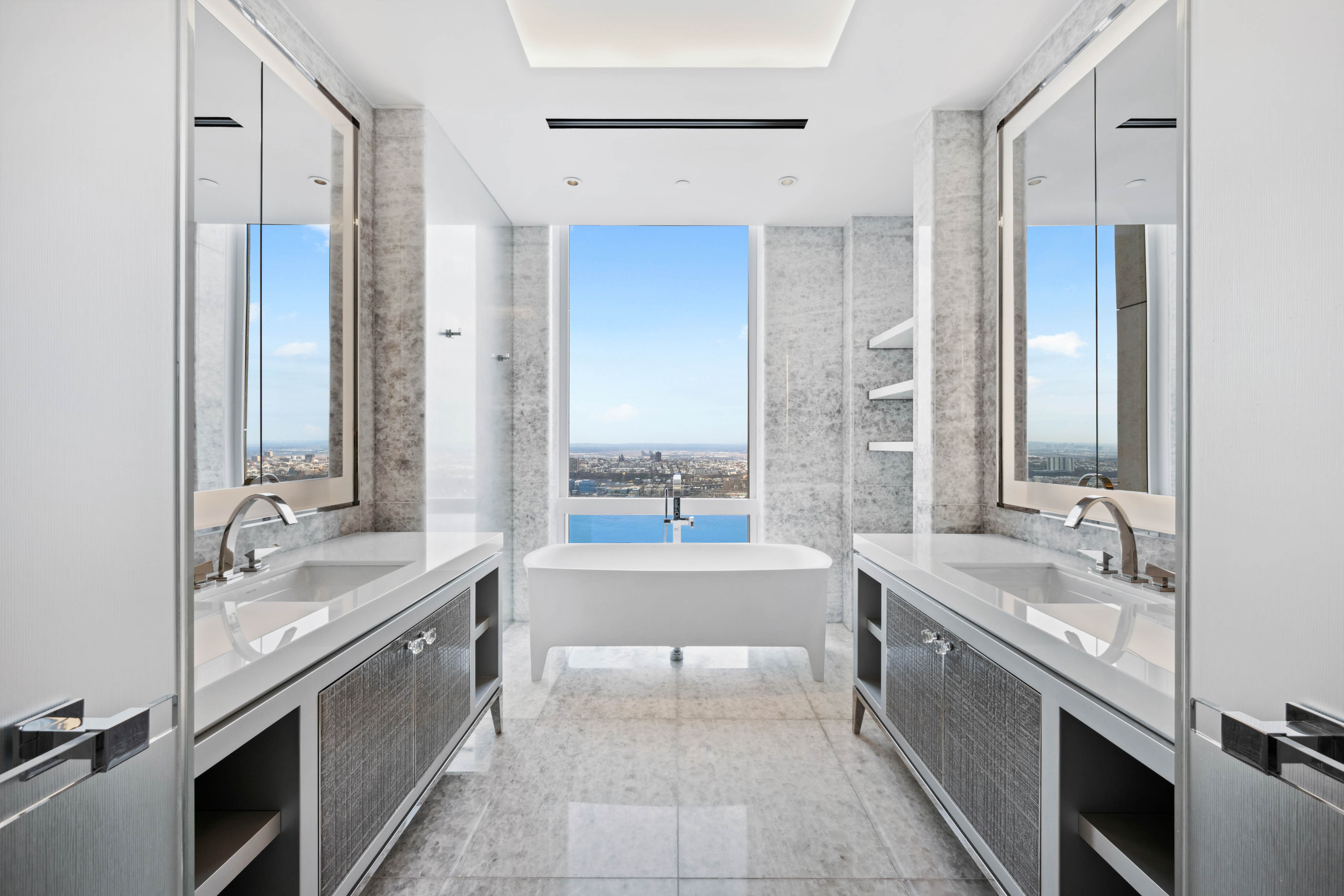 35 Hudson Yards, Unit 6201 Manhattan, NY 10001 - Photo 6 of 32 a bathroom with a tub sink and mirror