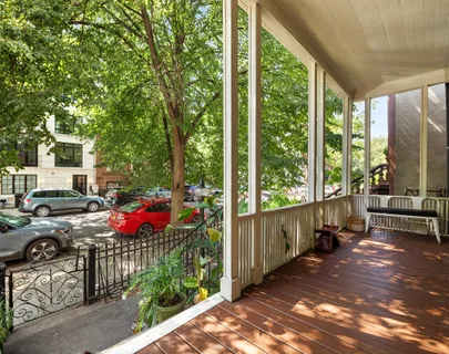 front view of a brick house with large windows