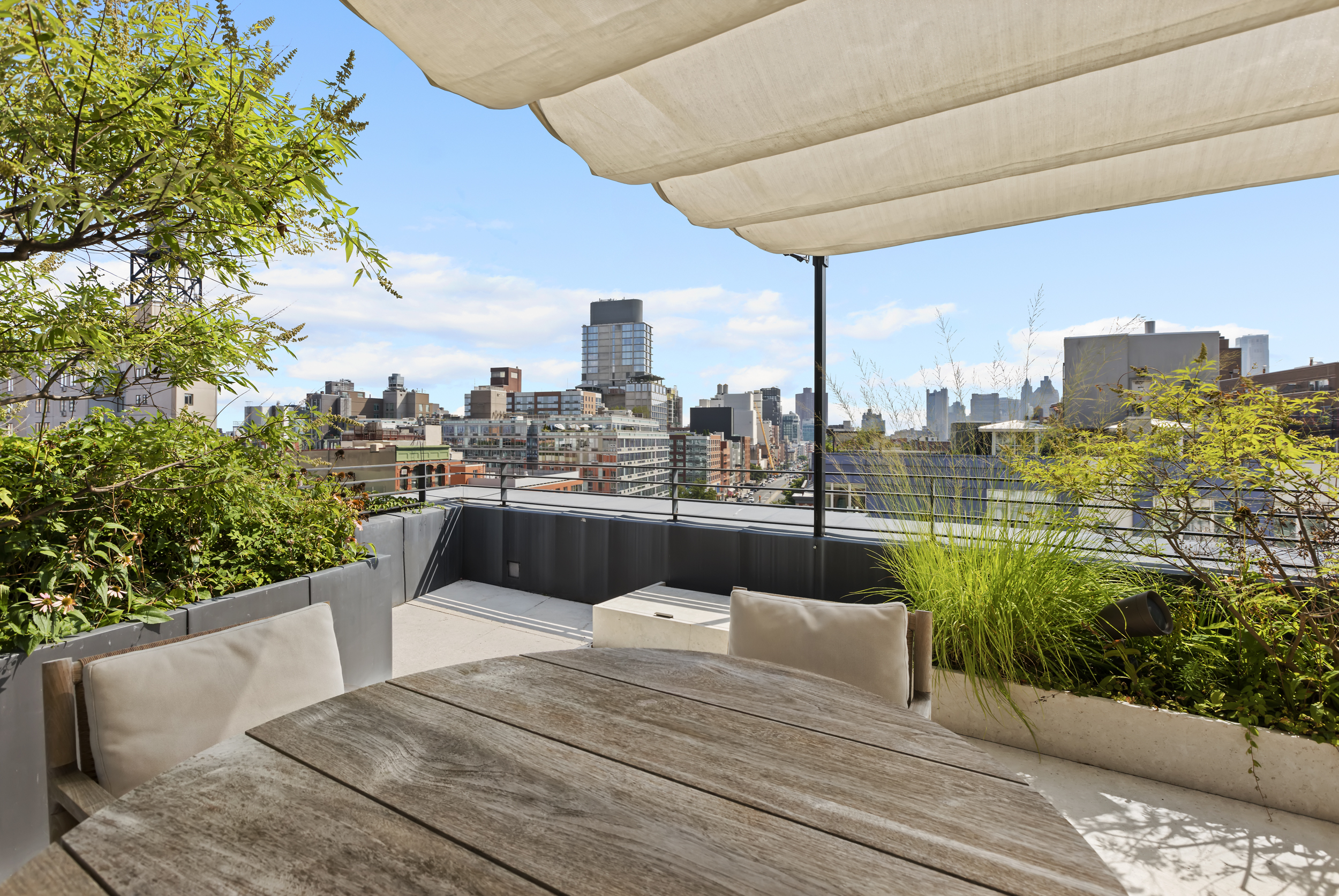 54 Bond Street, Unit PH Manhattan, NY 10012 - Photo 28 of 31 a view of a balcony with a table and chairs