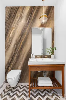 a bathroom with a sink mirror vanity and toilet