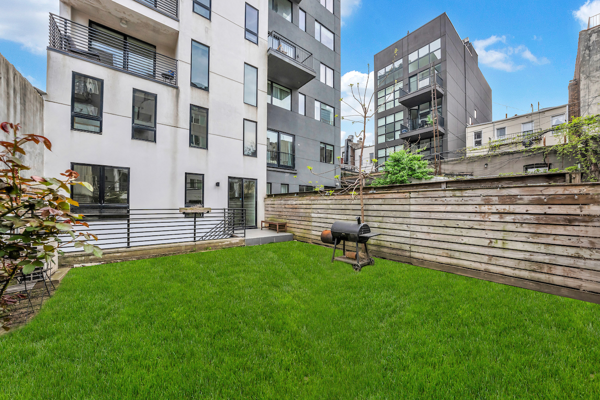79 Clay Street, Unit 1R Brooklyn, NY 11222 - Photo 4 of 10 a view of backyard with a chair under the garden