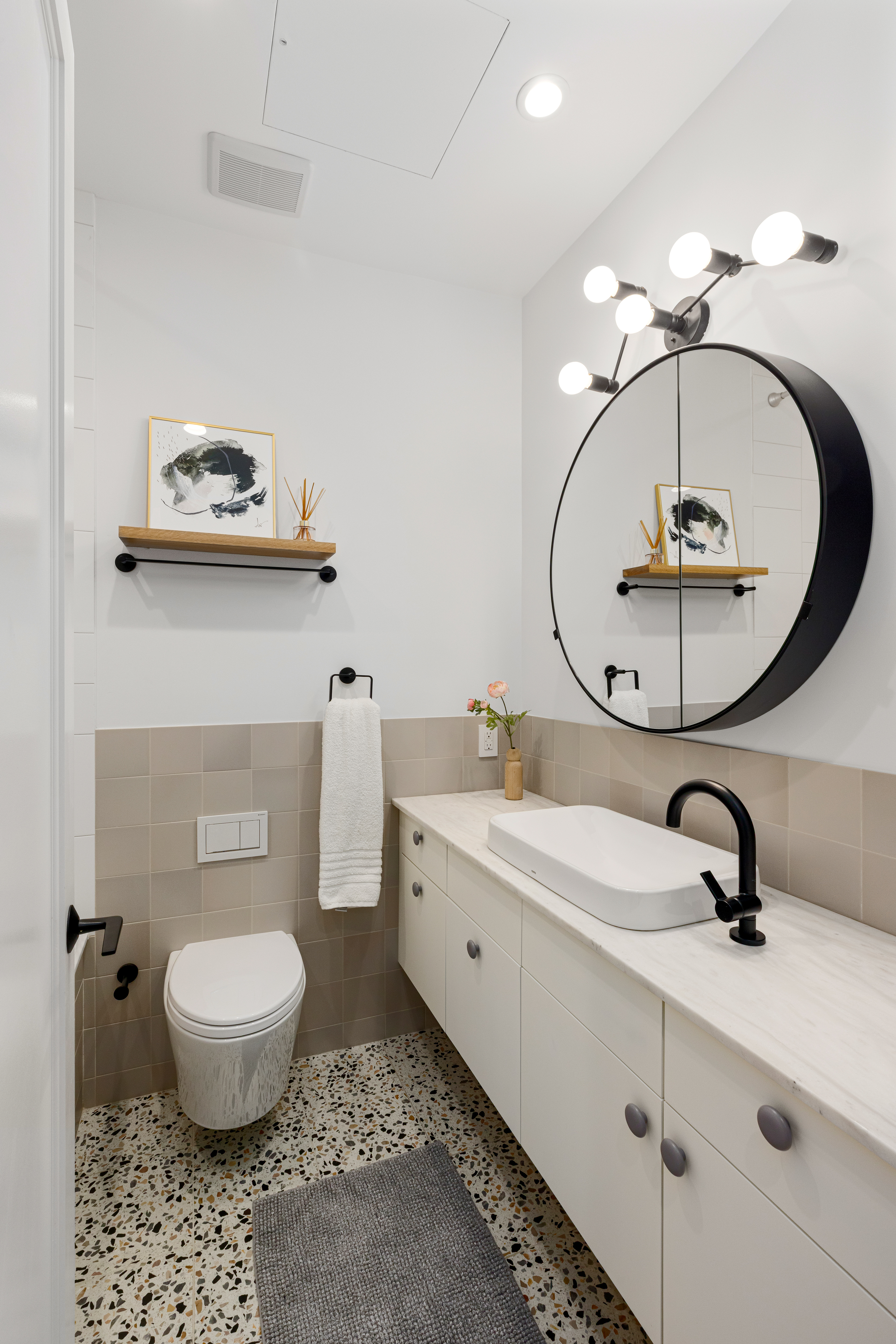 179 Devoe Street Brooklyn, NY 11211 - Photo 13 of 20 a bathroom with a toilet a sink and mirror