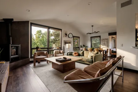 a living room with a large window and a fireplace