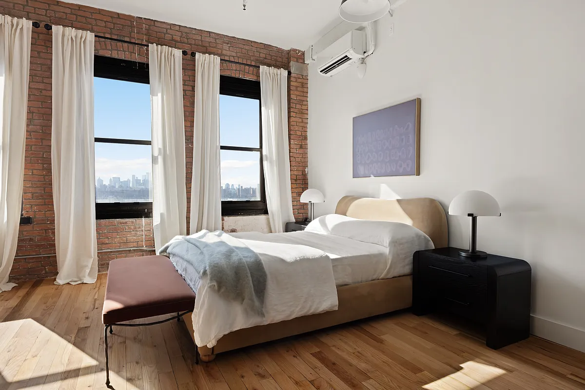 239 Banker Street, Unit 4K Brooklyn, NY 11222 - Photo 2 of 13 a bedroom with a bed lamp and a window
