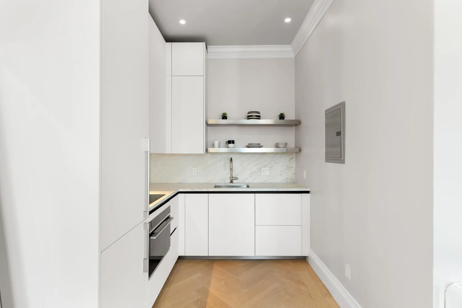 a kitchen with a sink a stove and cabinets