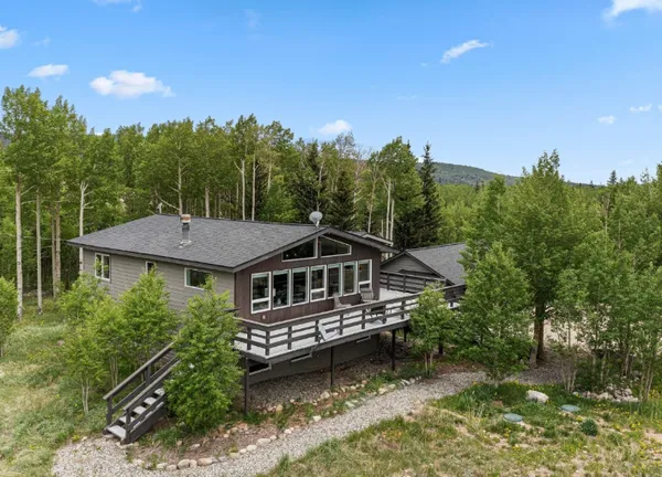 a aerial view of a house with swimming pool next to a yard