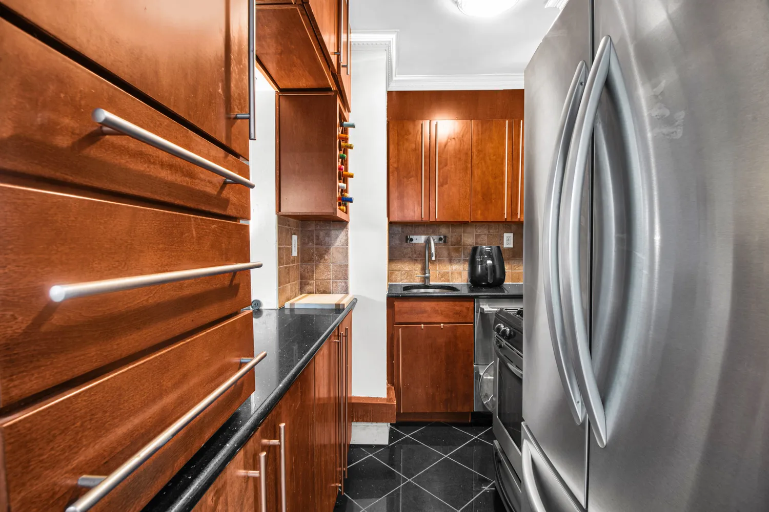 a kitchen with stainless steel appliances a refrigerator and a window