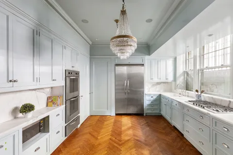 a kitchen with stainless steel appliances granite countertop a sink a stove and a refrigerator