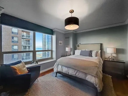 a bedroom with a large bed and a large window