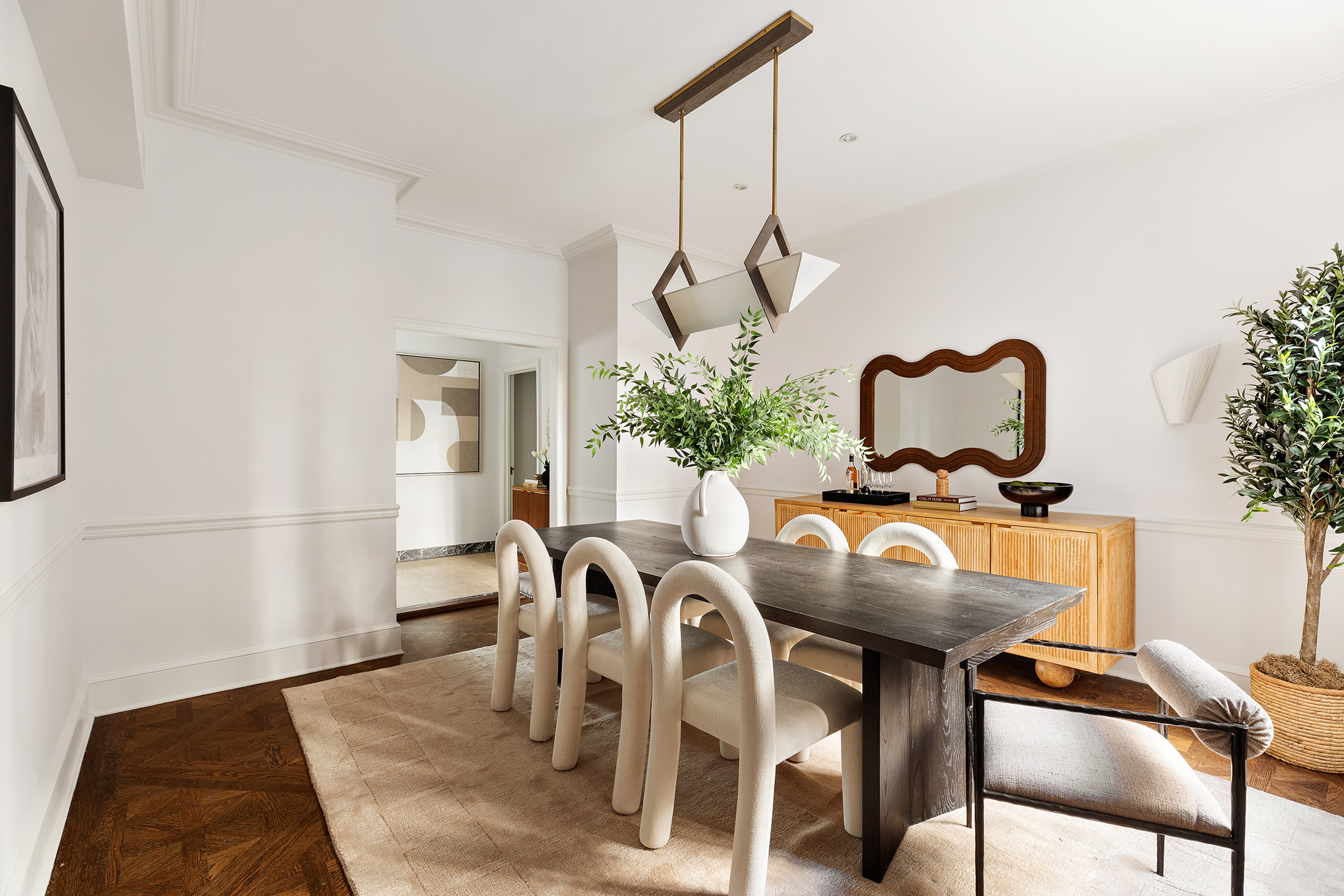115 East 67th Street, Unit 3C Manhattan, NY 10065 - Photo 6 of 21 a view of a dining room with furniture and a potted plant