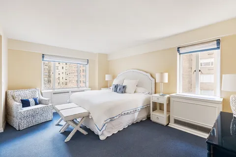 a bedroom with a bed chair and window