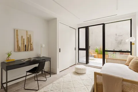 a bedroom with furniture and a window