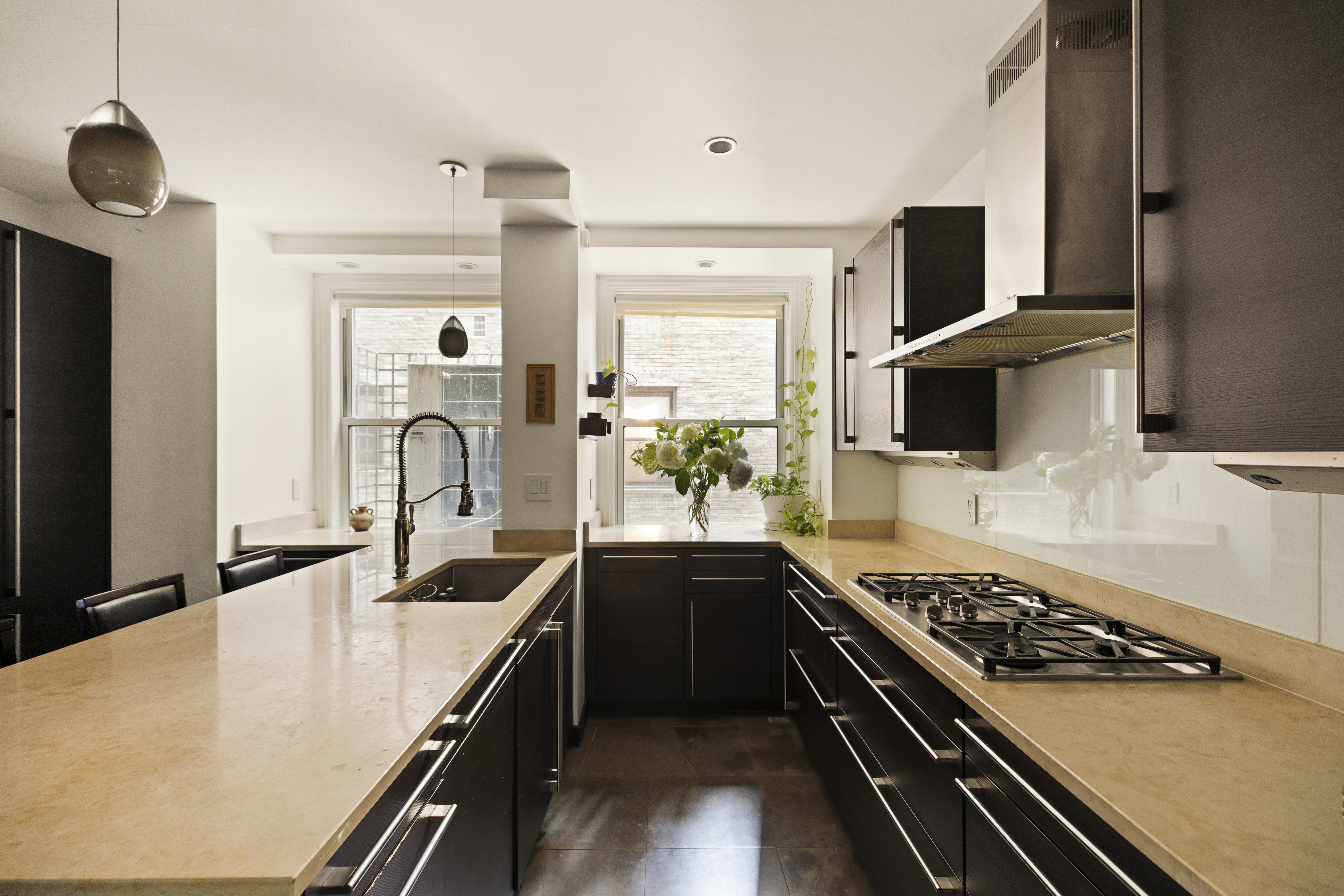 1158 5th Avenue, Unit 4A Manhattan, NY 10128 - Photo 8 of 24 a kitchen with stainless steel appliances a sink dishwasher stove refrigerator and microwave