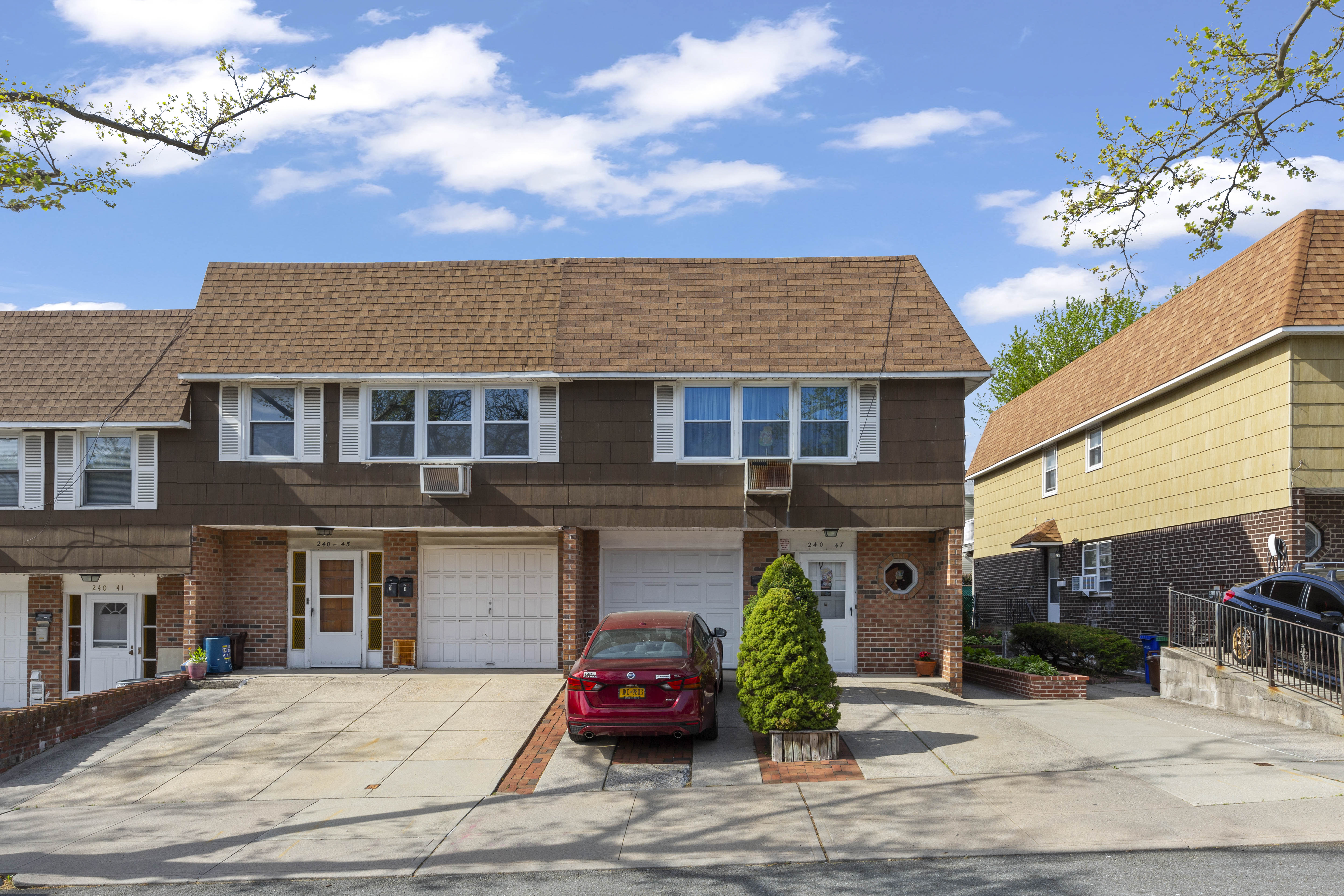 240-47 68th Avenue Queens, NY 11362 - Photo 2 of 39 a front view of a house with a yard