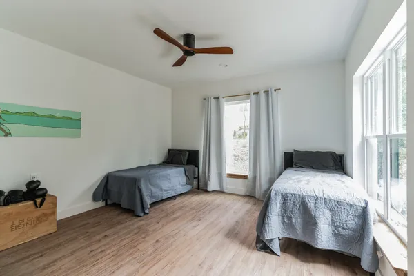a bedroom with a bed and wooden floor