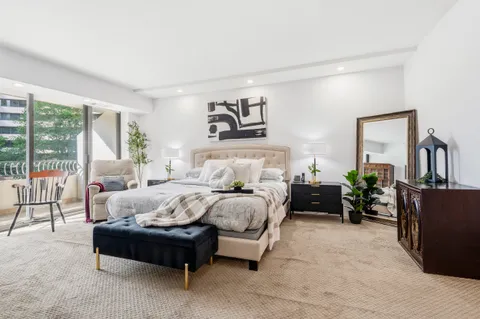 a bedroom with a bed and lamp