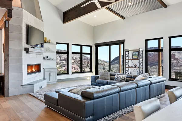 a living room with fireplace furniture and a large window