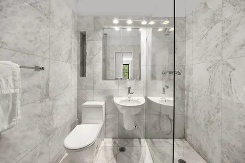 a bathroom with a toilet sink and shower