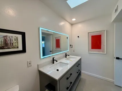 a bathroom with 2 sink and a mirror