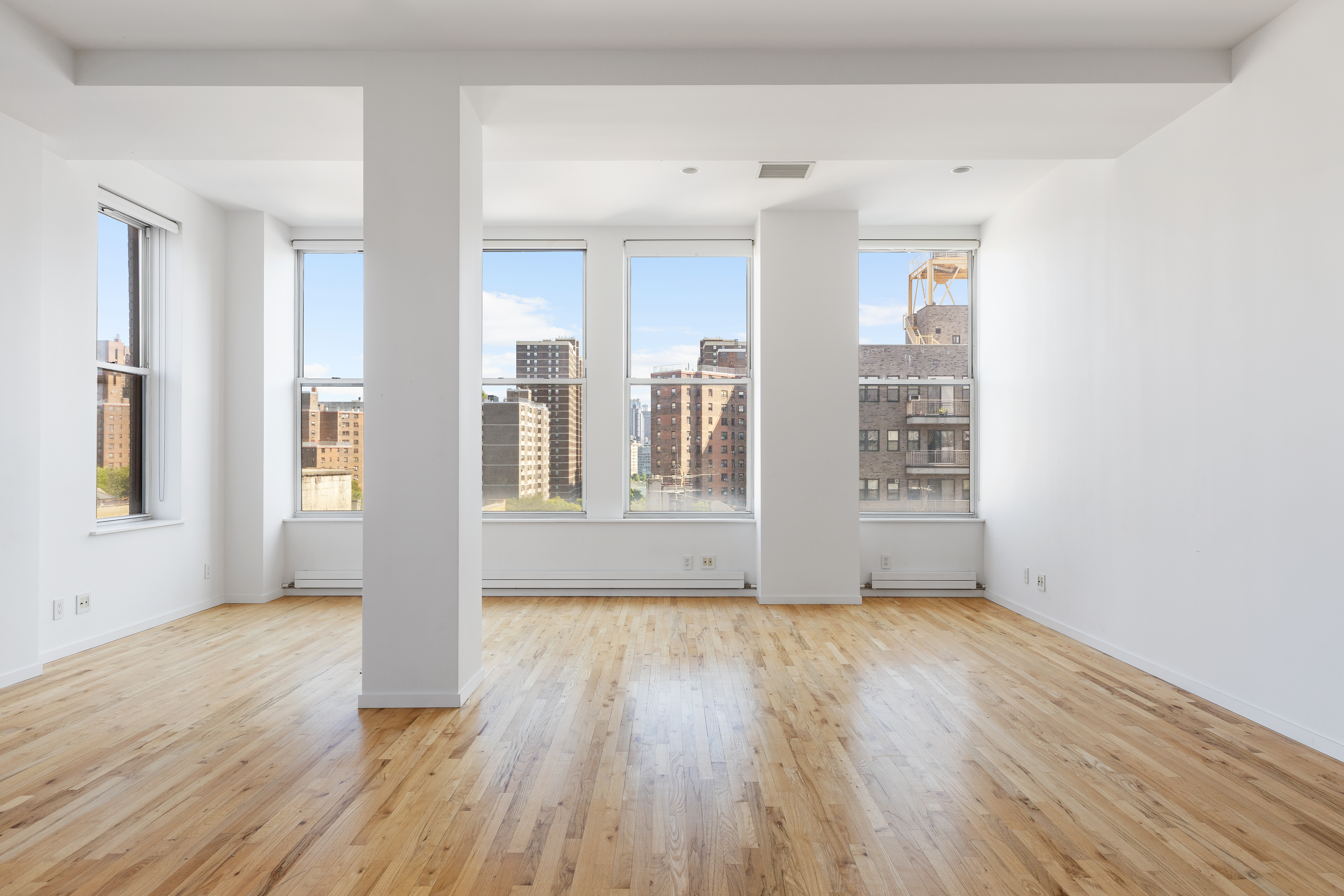 175 East Broadway, Unit 6D Manhattan, NY 10002 - Photo 4 of 18 a view of an empty room with wooden floor and a window