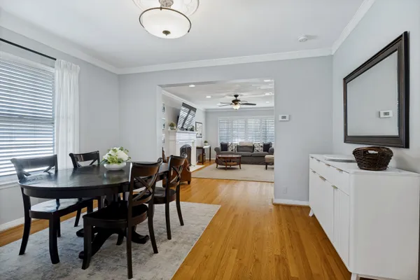 a kitchen with stainless steel appliances a table and chairs in it