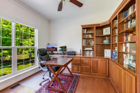 a work room with furniture and a book shelf