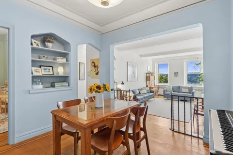 a dining room with a wooden table and chairs