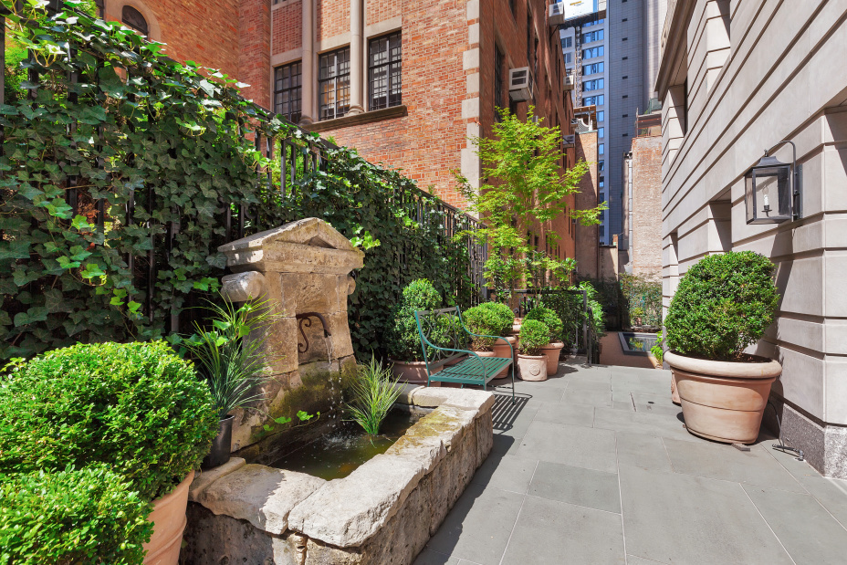 530 Park Avenue, Unit 4A Manhattan, NY 10065 - Photo 10 of 16 a view of a patio with plants and potted plants