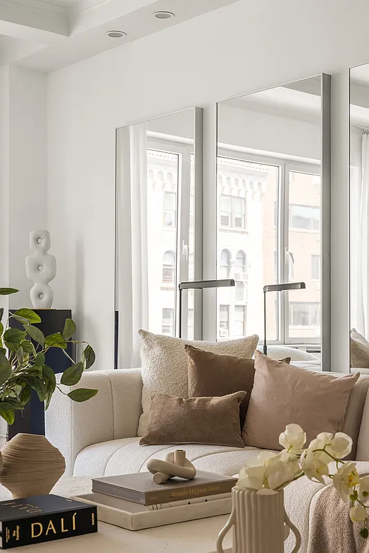 180 East 79th Street, Unit 14B Manhattan, NY 10075 - Photo 6 of 18 a living room with furniture and a large window