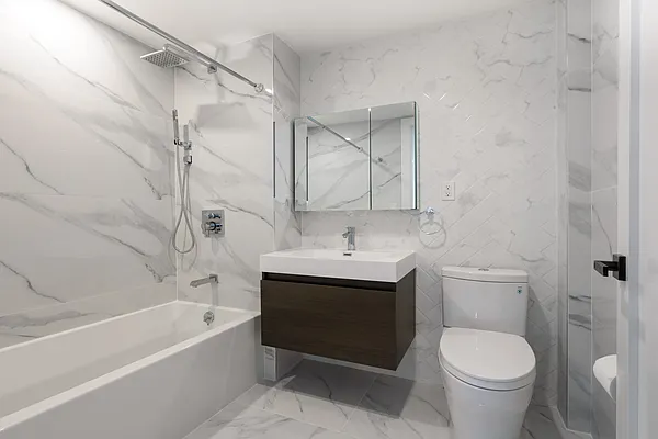 1673 Ocean Avenue, Unit PH4 Brooklyn, NY 11230 - Photo 7 of 13 a bathroom with a sink a toilet and a bathtub