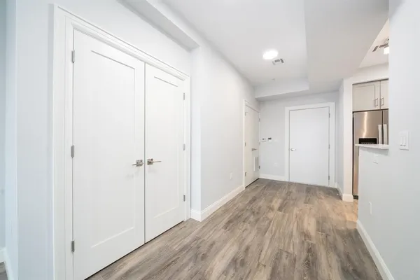 a view of hallway with wooden floor
