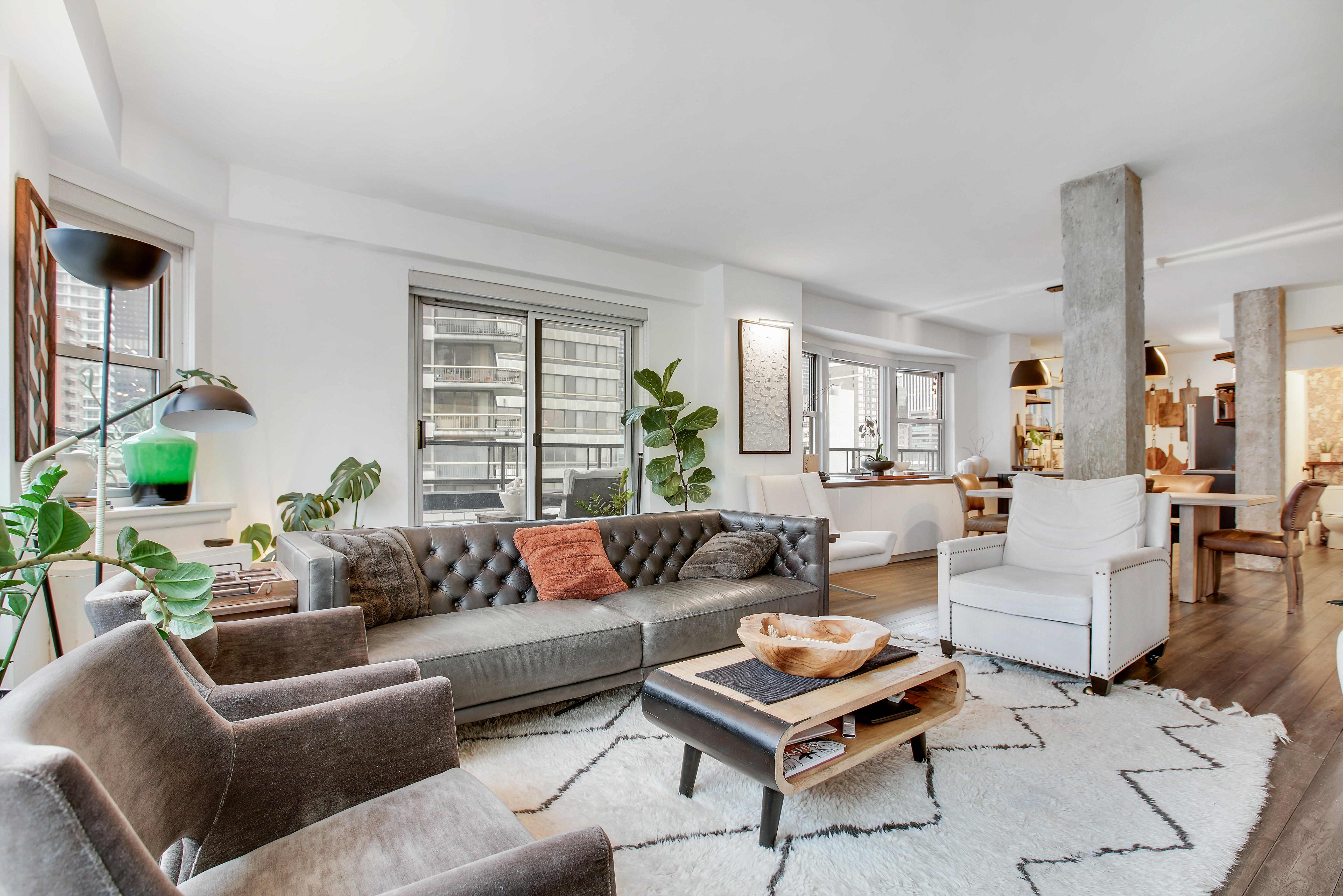 175 East 62nd Street, Unit 18B Manhattan, NY 10065 - Photo 1 of 18 a living room with furniture a rug and a window